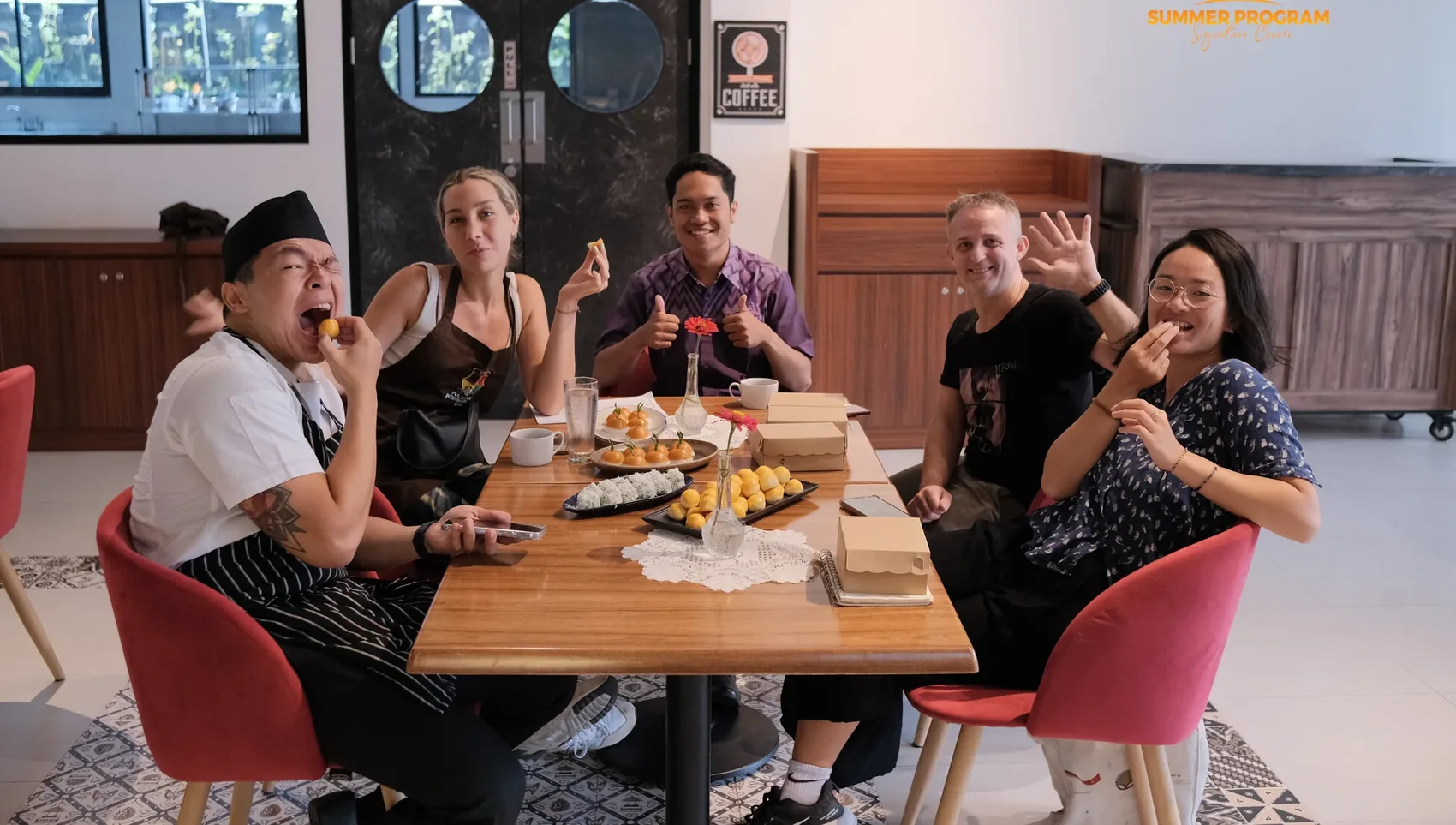 Culinary group seated together tasting their finished pastries