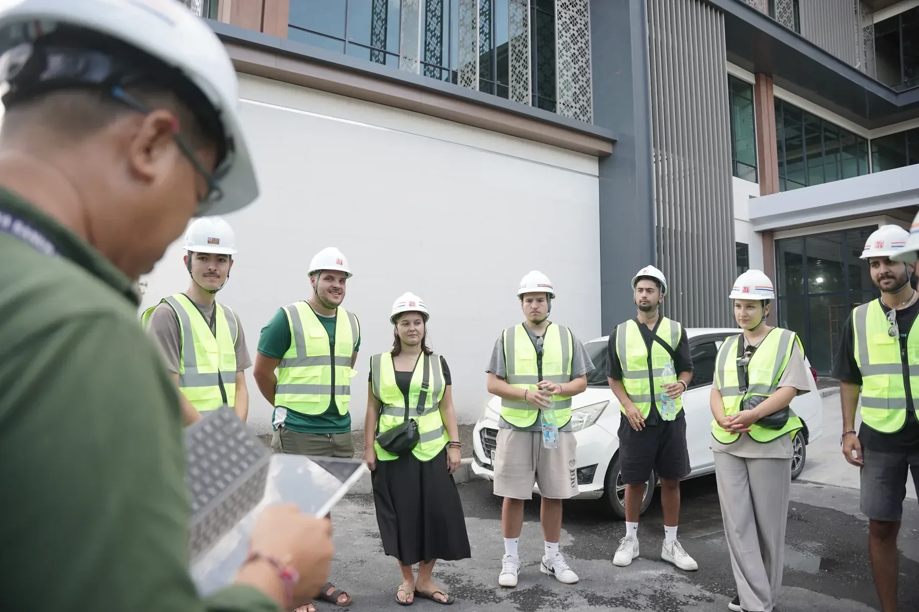 Students in hard hats and high-vis vests on a site visit
