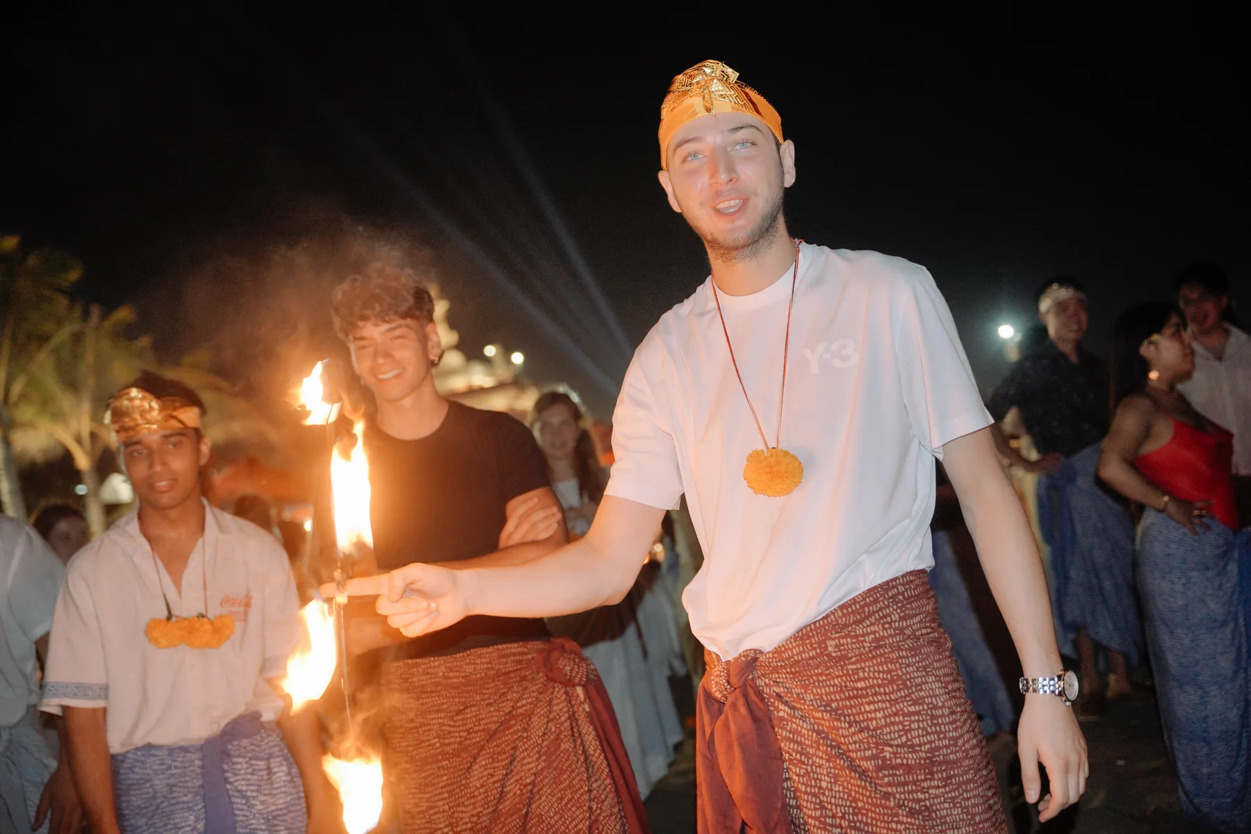 Students lighting a torch together for the fire show at the Welcoming Dinner