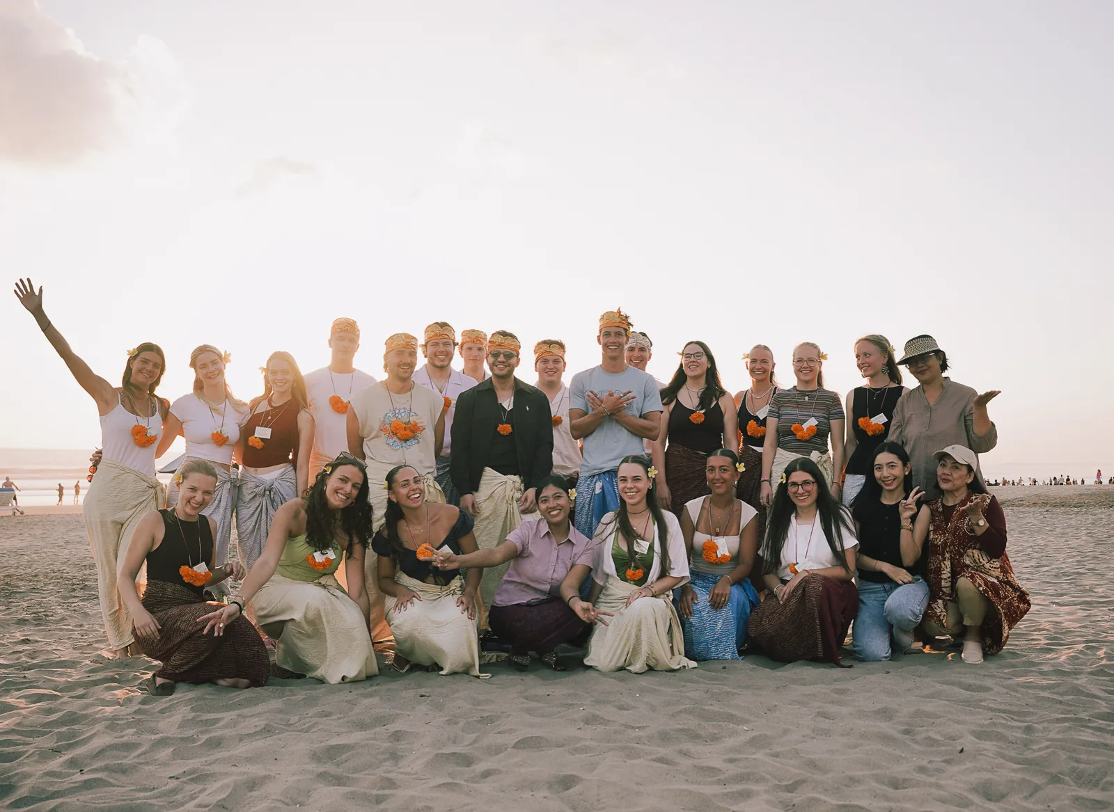 The full Winter Class 2026 cohort and team on the beach at sunset