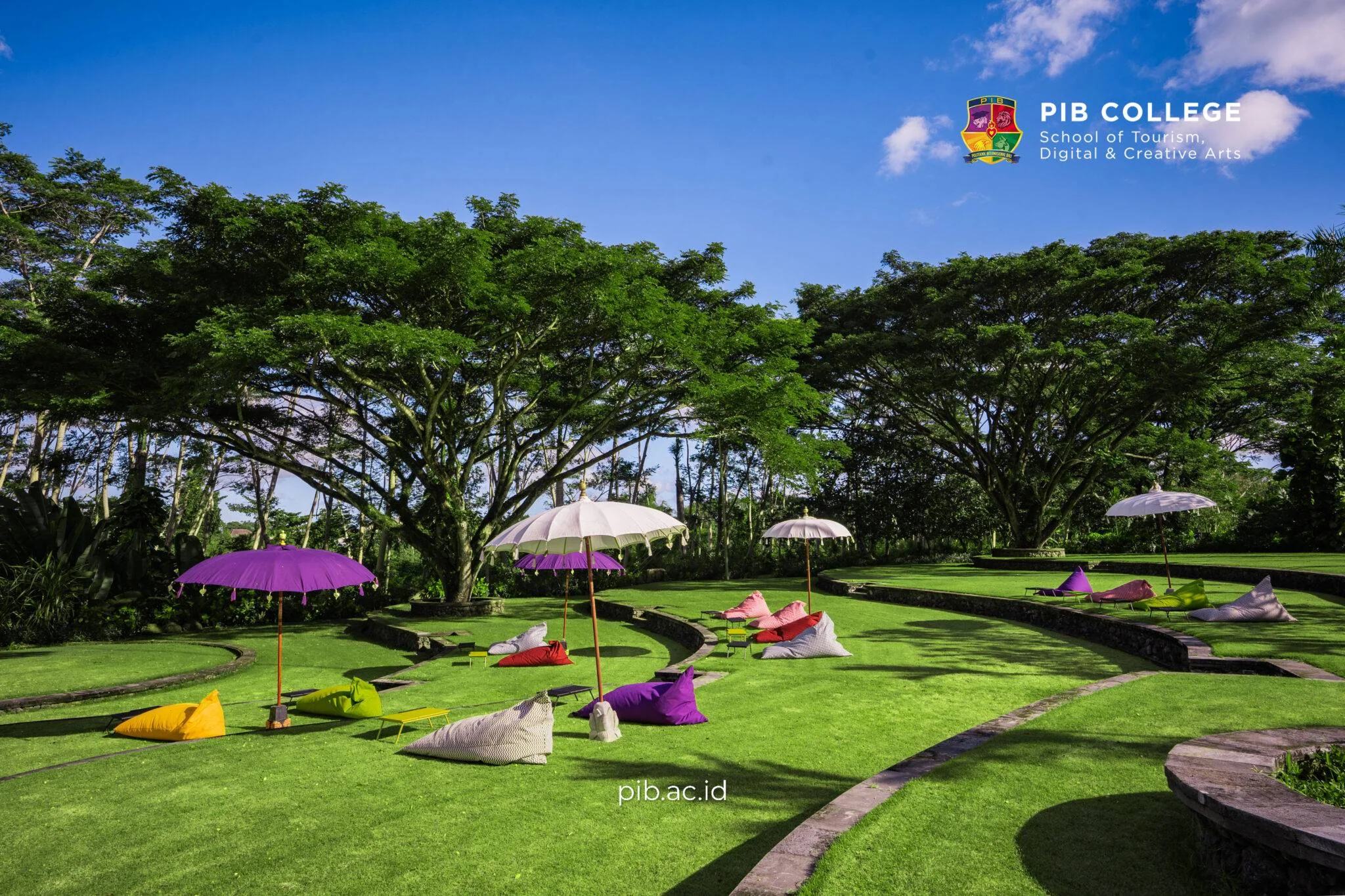 Students in an outdoor workshop surrounded by rice fields at PIB College