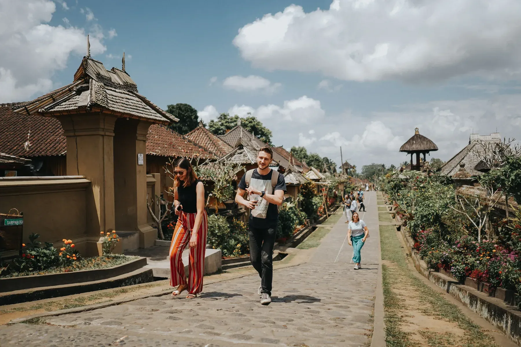 Students walking through a traditional Balinese village