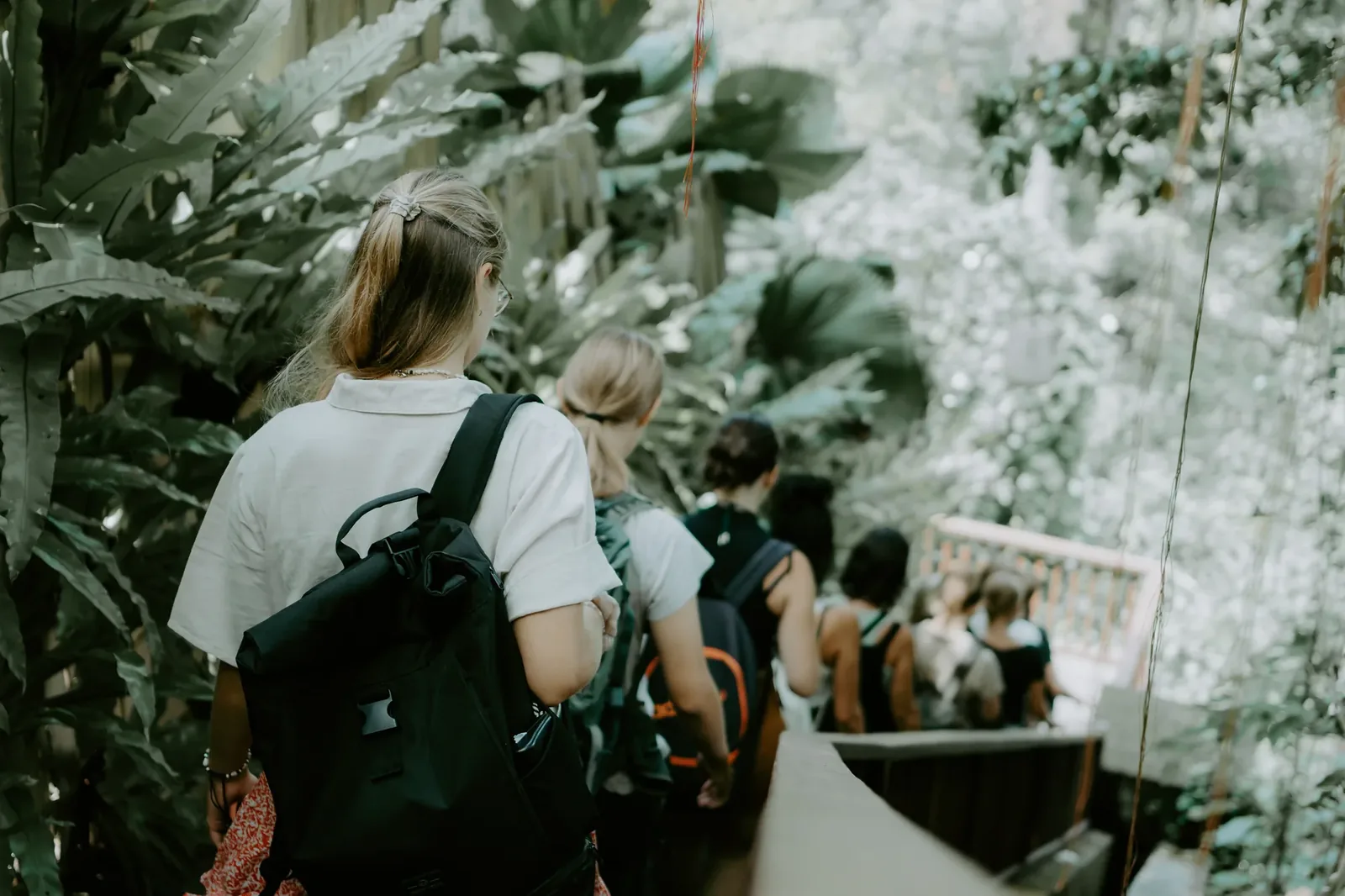 Students walking into the bamboo architecture of Ulaman Eco Resort