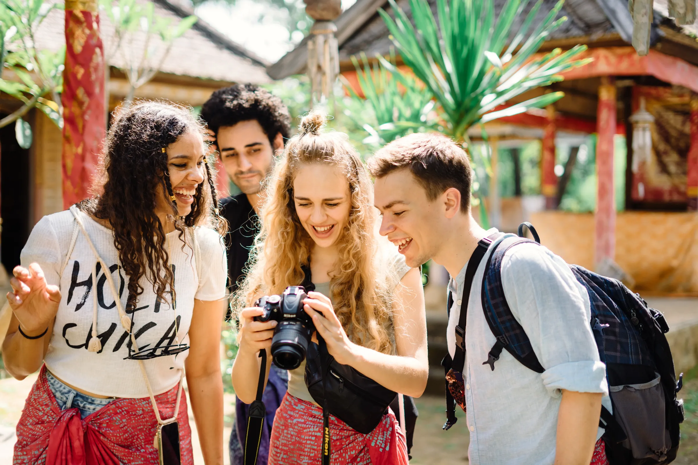 Four students reviewing a photograph together on a camera