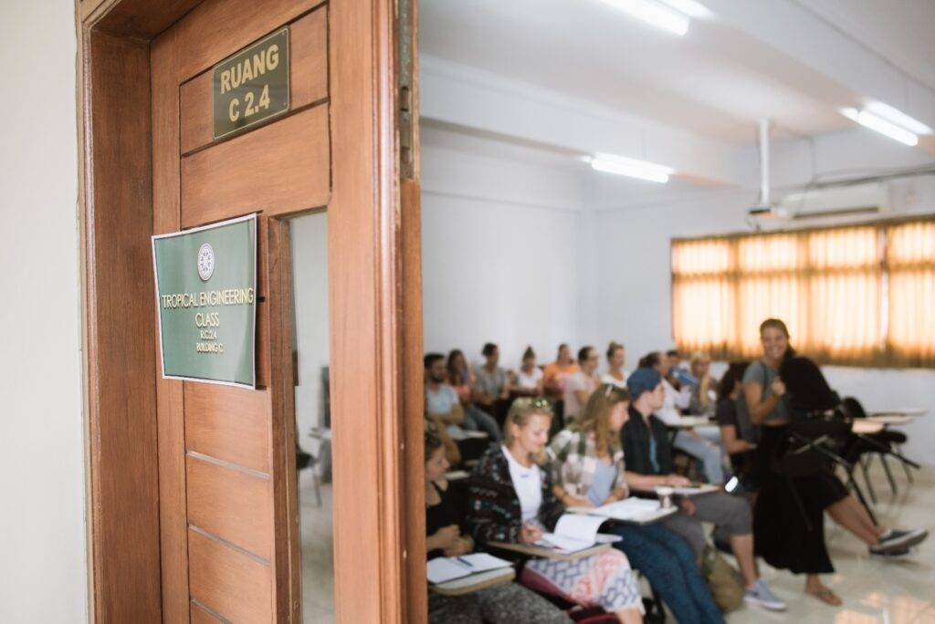 A view through an open door into a classroom at Udayana University (UNUD), where students in the Southeast Asian Architecture study abroad program are engaged in a lecture.
